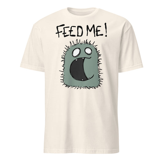 Beige t-shirt with a cartoon character and 'FEED ME!' text on a white background