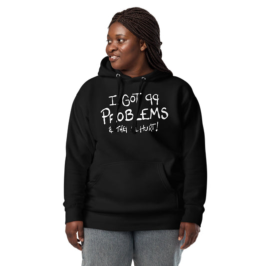Person wearing a black hoodie with text I got 99 problems and they all hurt on a white background