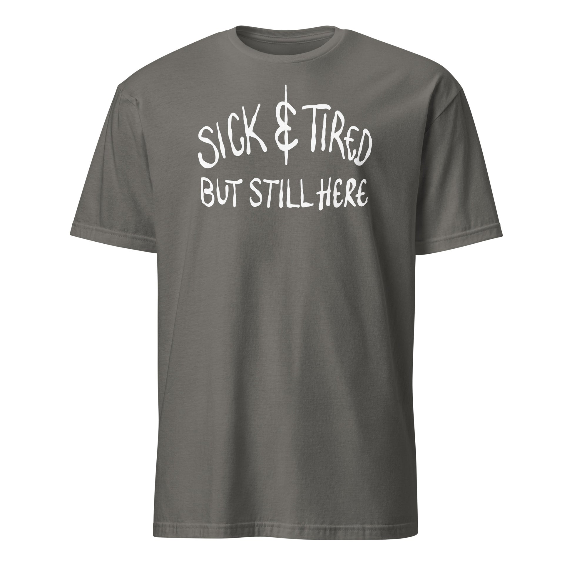 Gray t-shirt with white text 'SICK & TIRED BUT STILL HERE' on a white background
