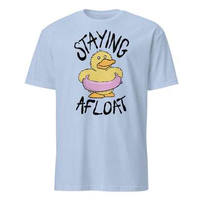 Light blue t-shirt with a cartoon duck and text 'STAYING AFLOAT' on a white background